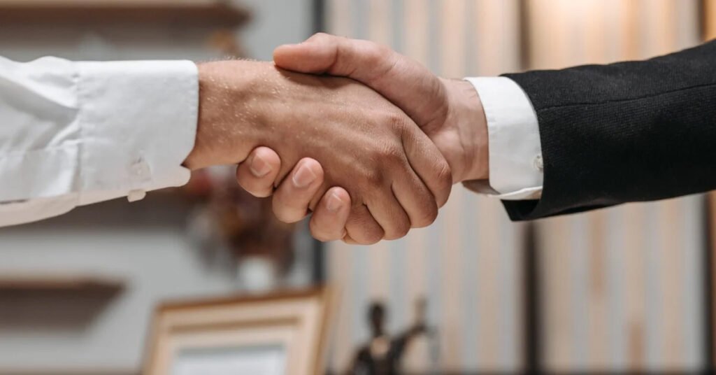 2 men shaking hands in a law firm